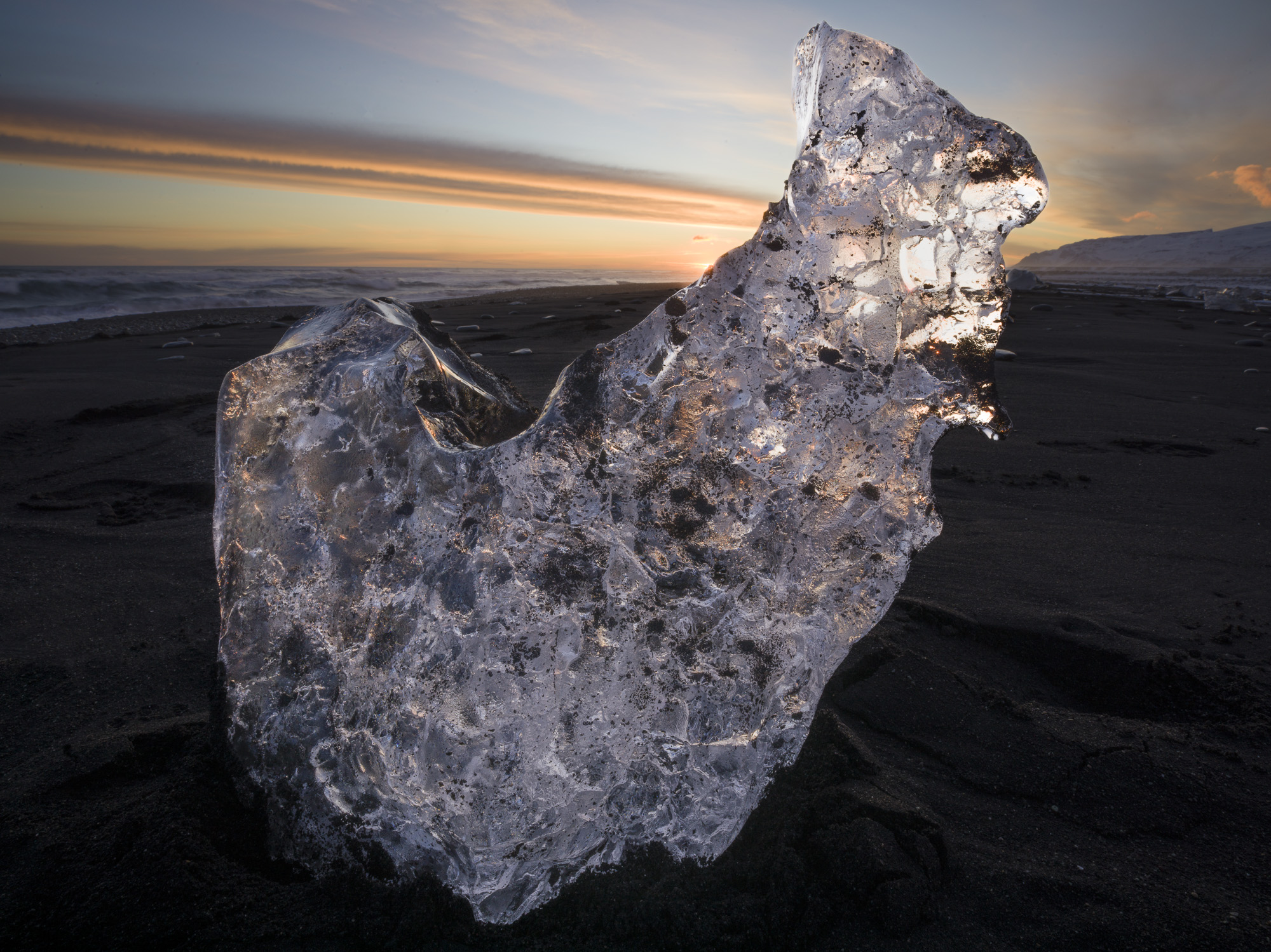 As Iceland's Jökulsárlón glacier empties into the ocean blocks of ice break off and wash up on the black sand beach at Breiðamerkursandur.