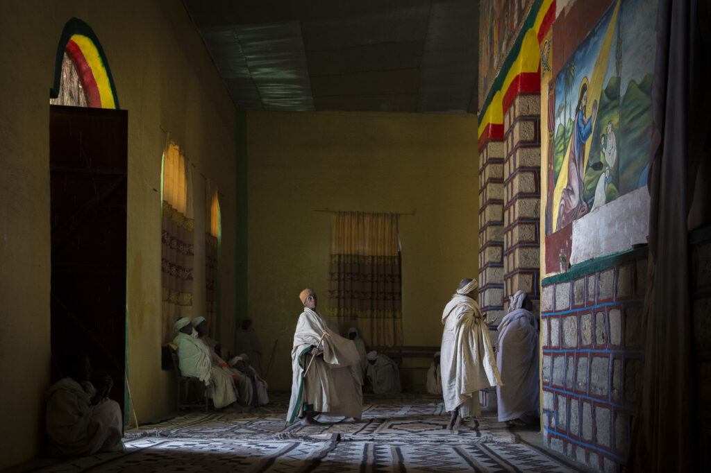Women praying at Checho Medhnealem church.