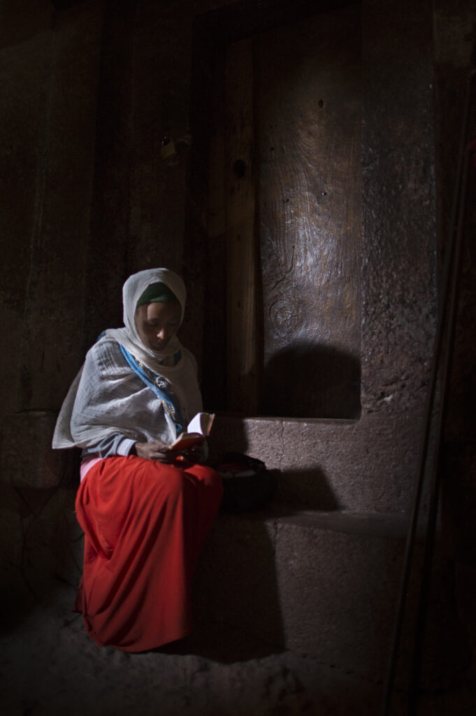 Women praying in a stone church in Lalibela