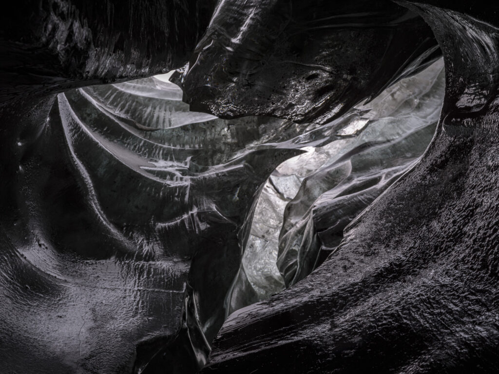 Black ice forms a cave in Iceland. The black color is created by frozen volcanic ash.