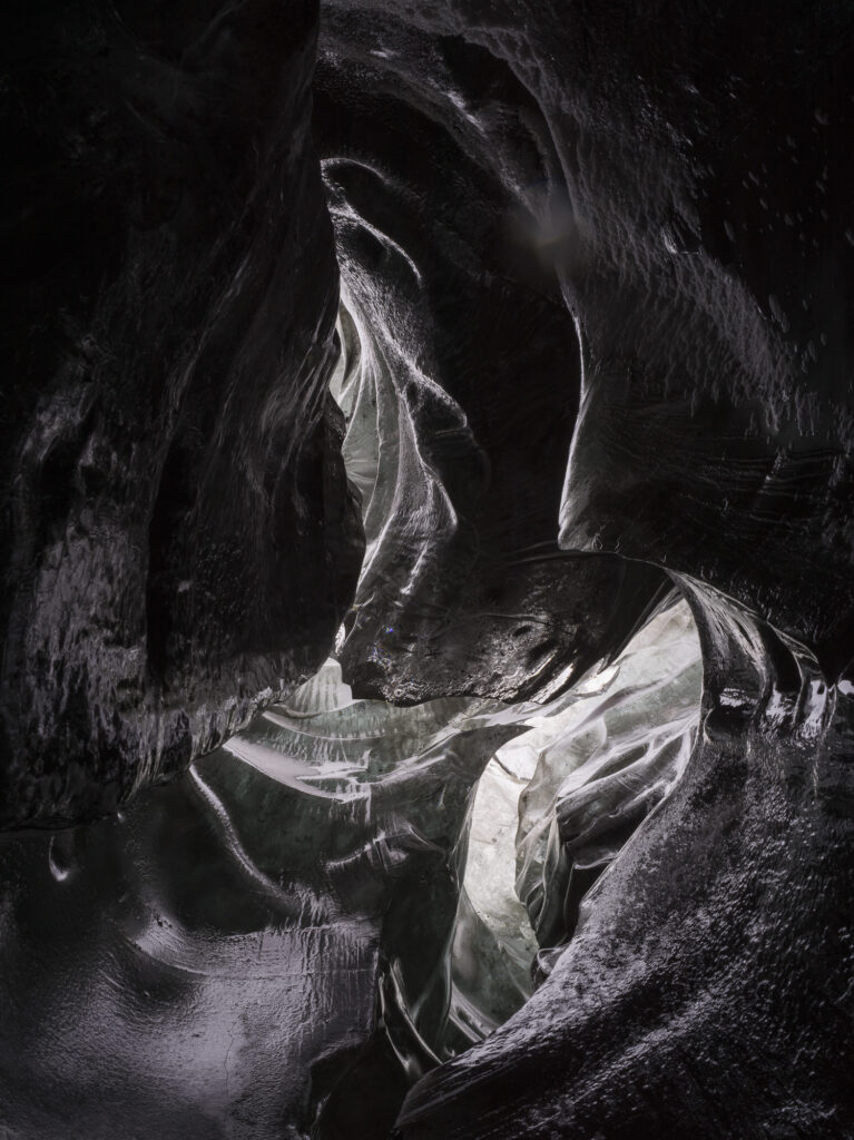Black ice forms a cave in Iceland. The black color is created by frozen volcanic ash.