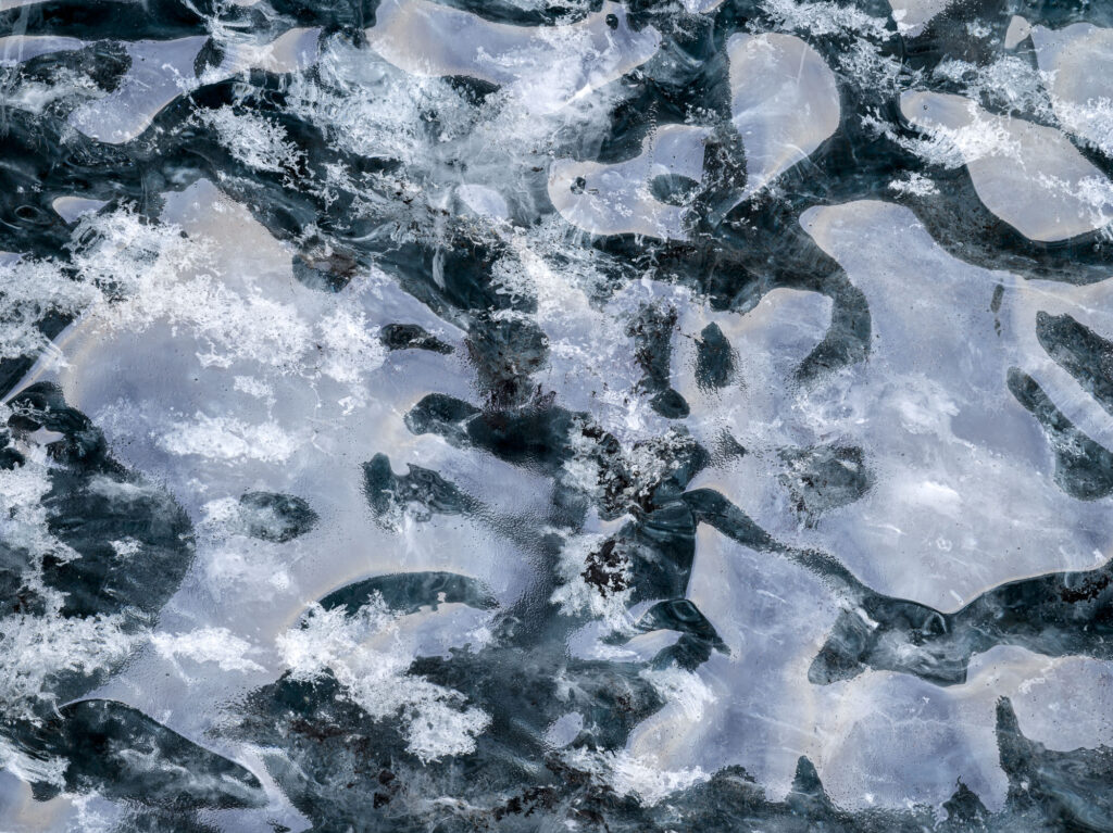 Light reflected on the wall of the Blue Rose ice cave in Iceland's J&ouml;kuls&aacute;rl&oacute;n glacier forms an abstract pattern.