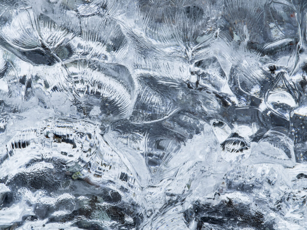 As Iceland's J&ouml;kuls&aacute;rl&oacute;n glacier empties into the ocean blocks of ice break off and wash up on the black sand beach at Brei&eth;amerkursandur.