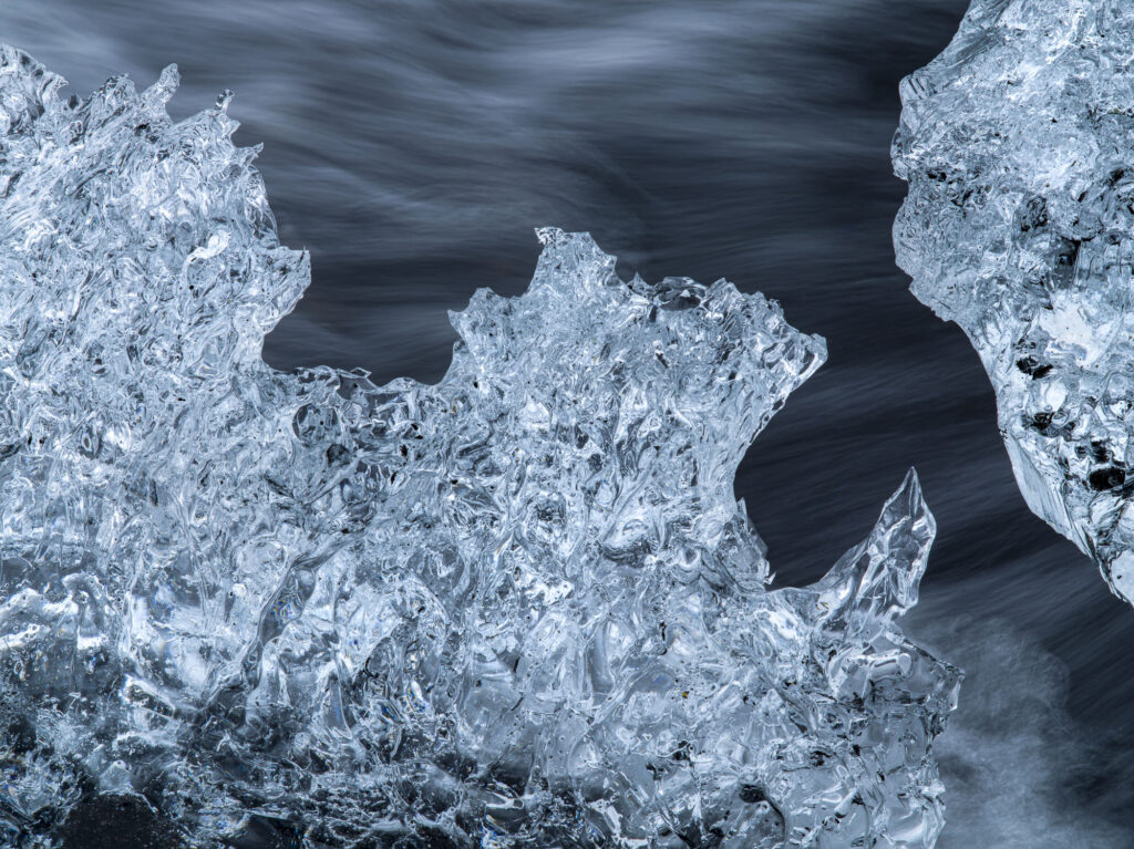As Iceland's J&ouml;kuls&aacute;rl&oacute;n glacier empties into the ocean blocks of ice break off and wash up on the black sand beach at Brei&eth;amerkursandur.