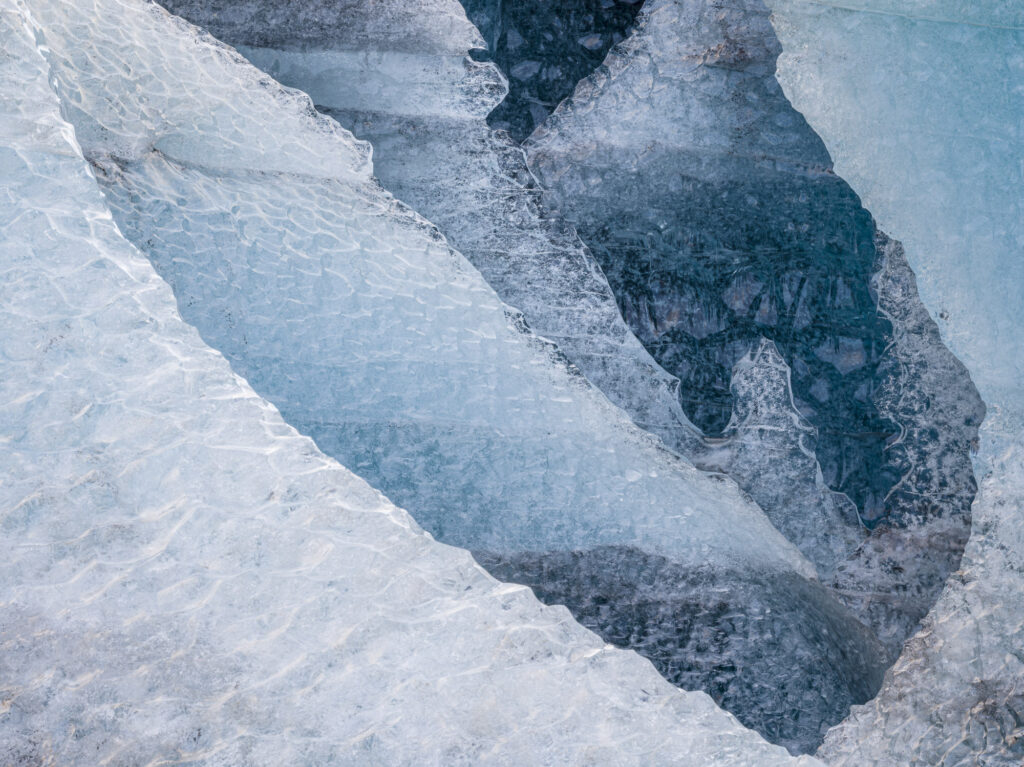 Six walls of ice gaurd rhe entrance to the Blue Rose ice cave in Iceland's J&ouml;kuls&aacute;rl&oacute;n glacier. The older ice is a deeper blue because more of the air bubbles have been squeezed out over time.