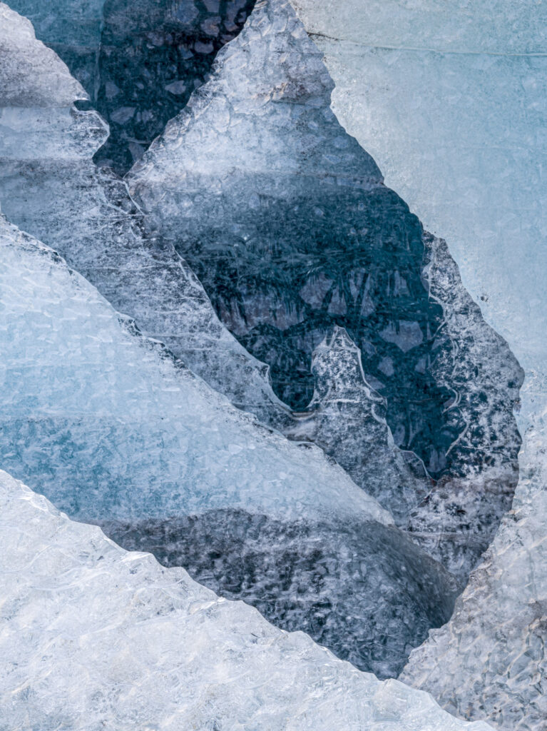 Six walls of ice gaurd rhe entrance to the Blue Rose ice cave in Iceland's J&ouml;kuls&aacute;rl&oacute;n glacier. The older ice is a deeper blue because more of the air bubbles have been squeezed out over time.