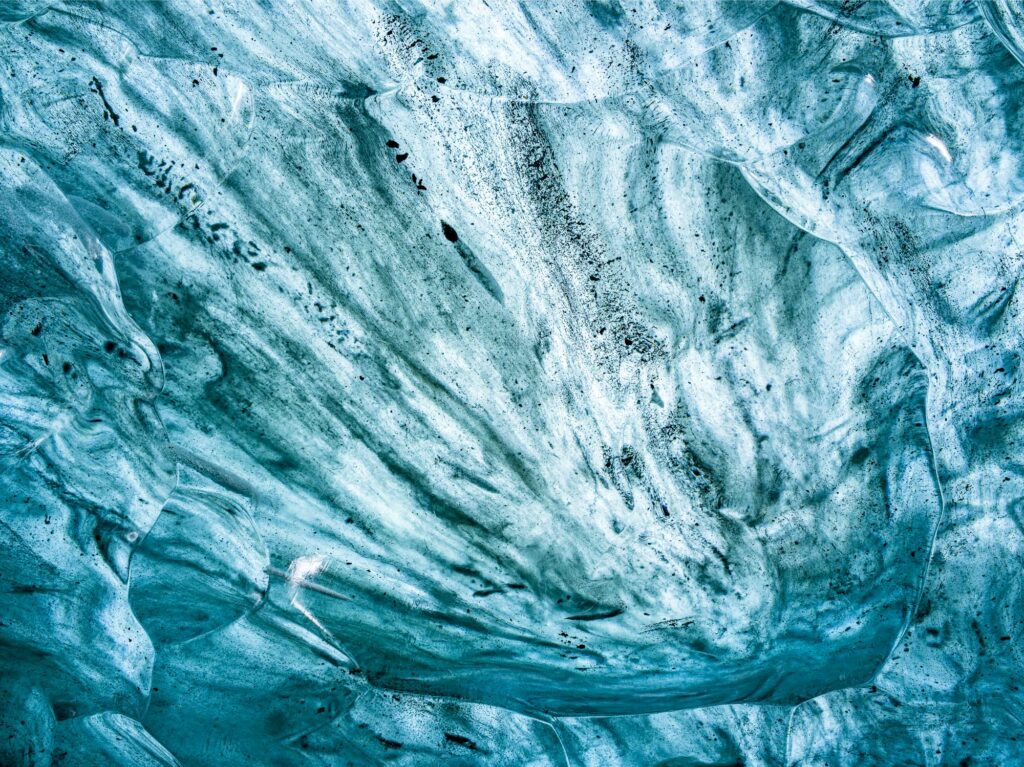 As Iceland'a glaciers melt they form ice caves - wonderlands of shape and color.