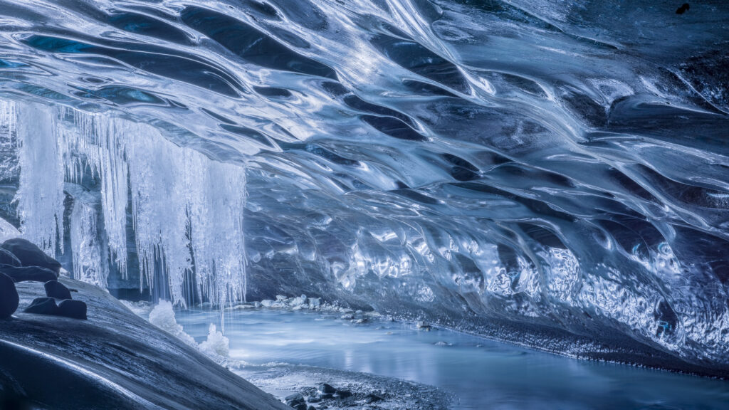 As Iceland'a glaciers melt they form ice caves - wonderlands of shape and color.