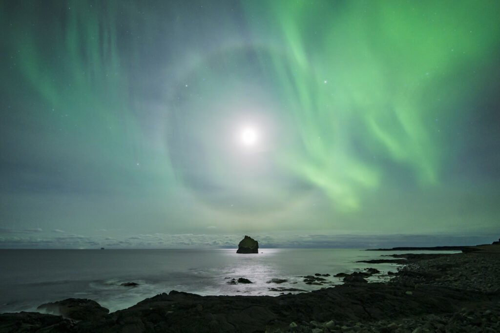 A 22 degree halo and an aurora off the coast of southwest Iceland.
