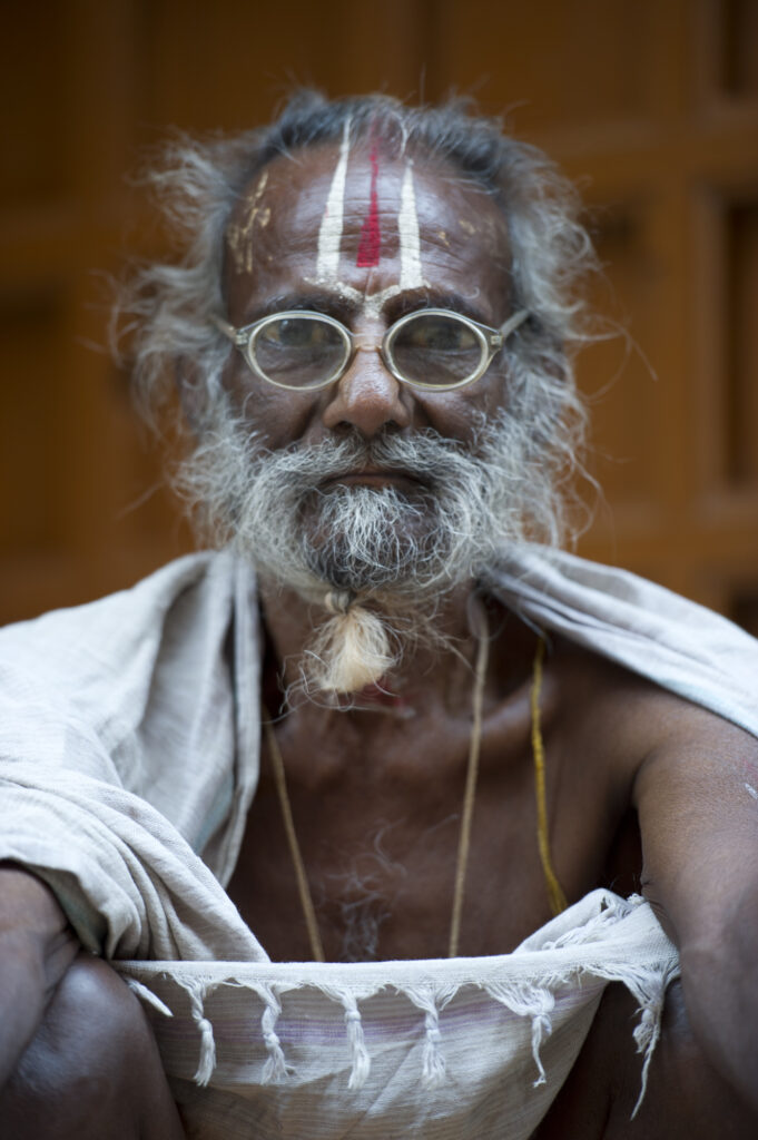 A sadhu sits on the steps outside a temple in Varanasi.