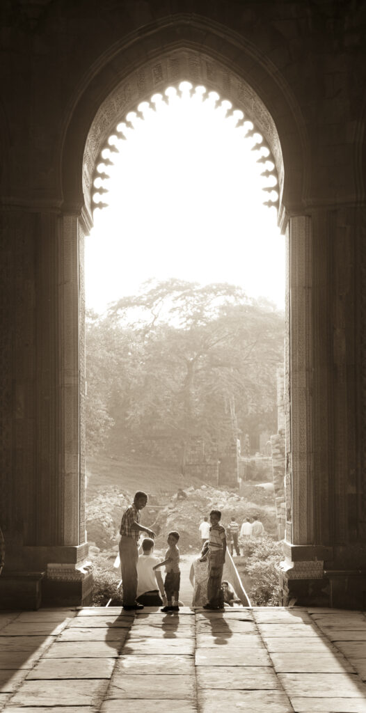A family gathers in an archway at Qutab Minar in New Delhi.