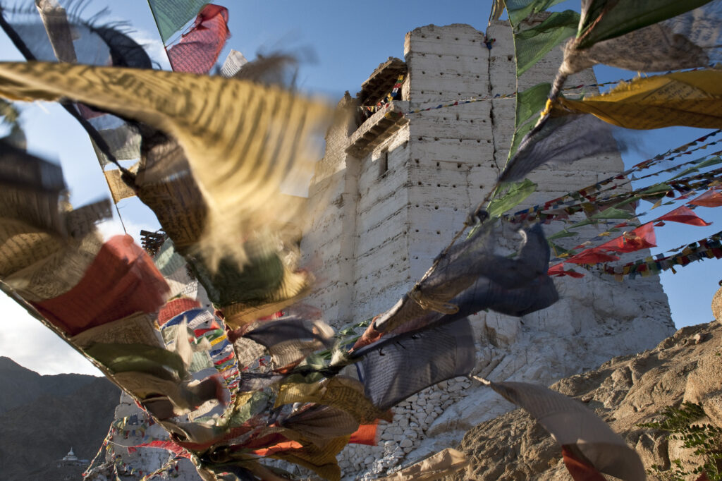 Prayer flags flap in the wind near a Buddhist monestary in Ladakh.