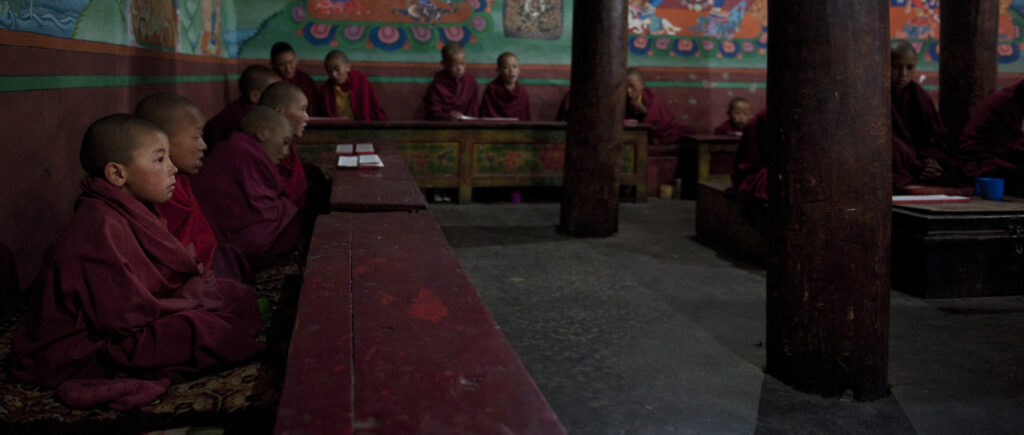 Young monks attend morning prayer in a Buddhist monestary in Ladakh.