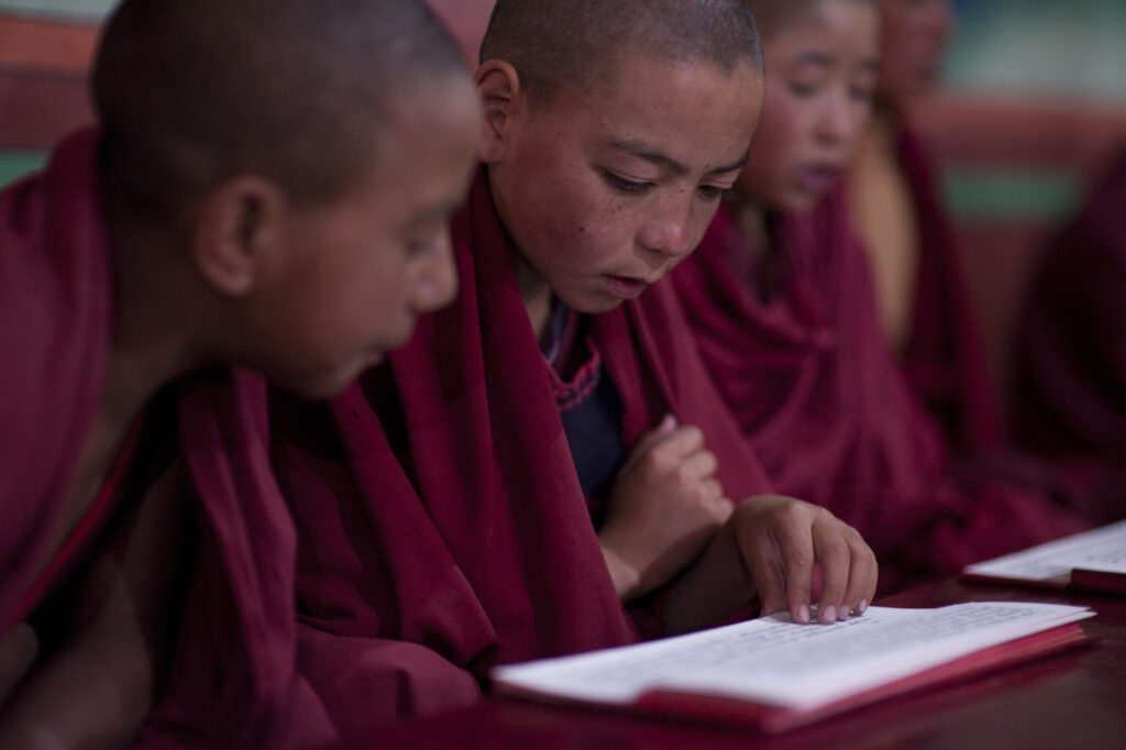 Young monks attend morning prayer in a Buddhist monestary in Ladakh.