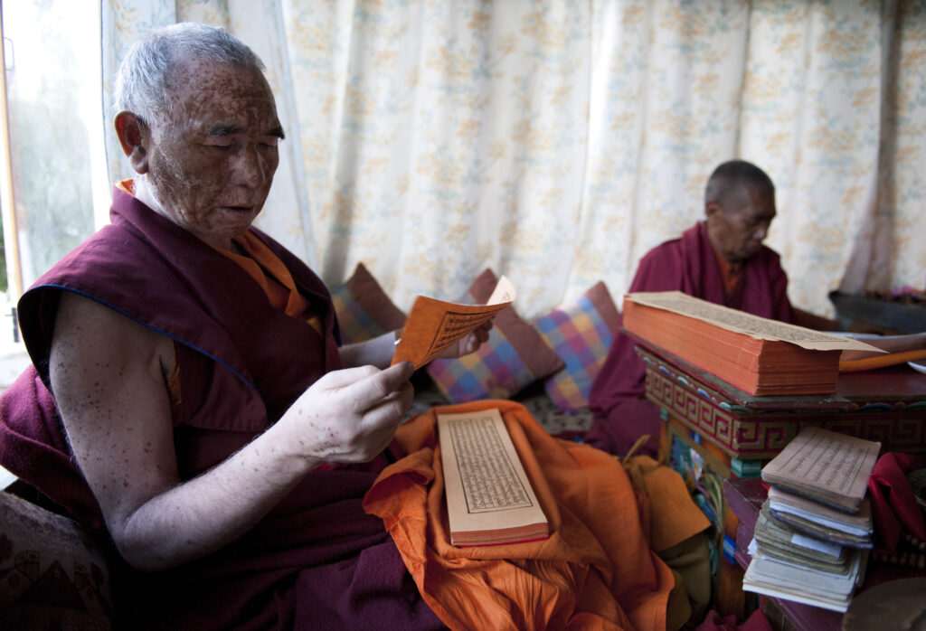 Monks chanting in a private home in Ladakh.