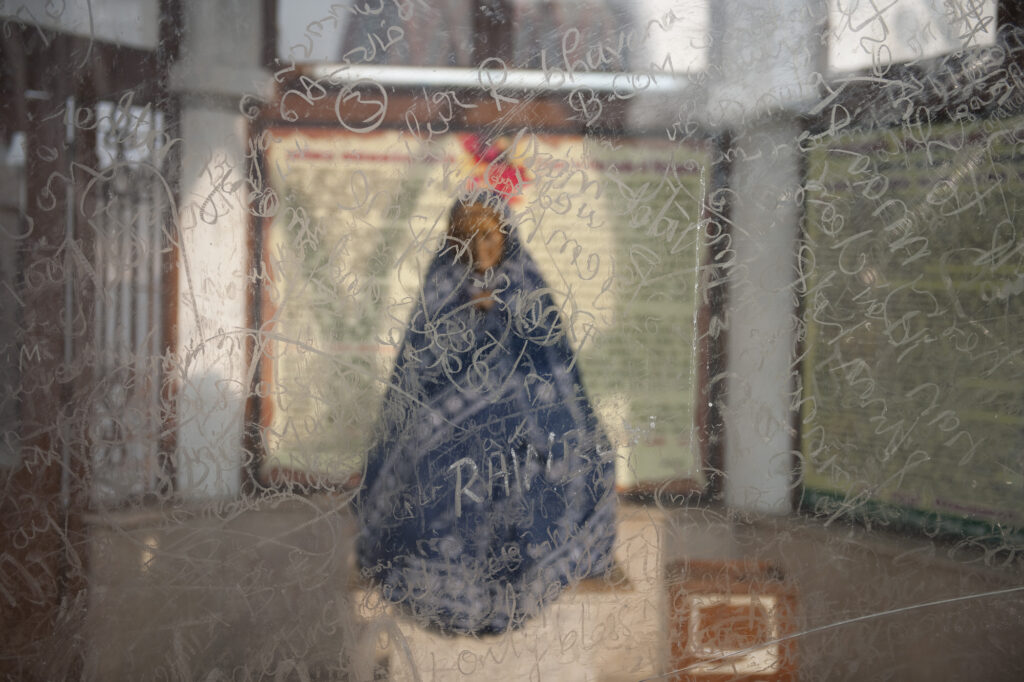 Graffiti in front of a statue of Mary in St Thomas' Cathedral in Chennai