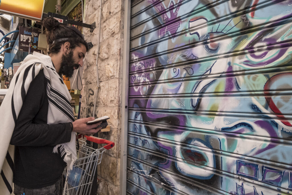An orthodox man praying in a market