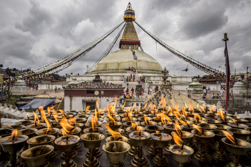 Butter lamps in front of Kathmandu's Boudhanath Stupa