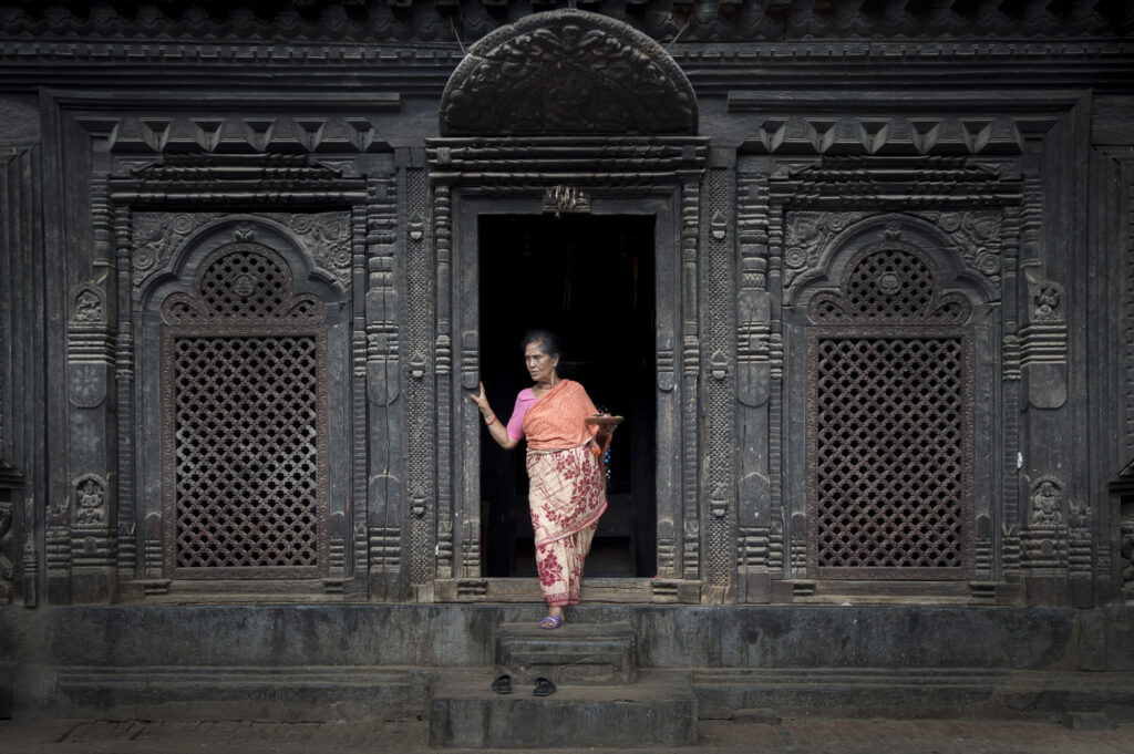 A woman steps out of a temple near Bhaktapur's Durbar Square
