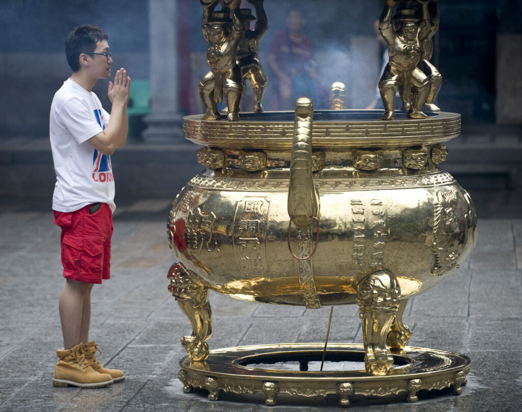 Ancient and modern are contrasted every day at Longshan Temple, Taipei, Taiwan