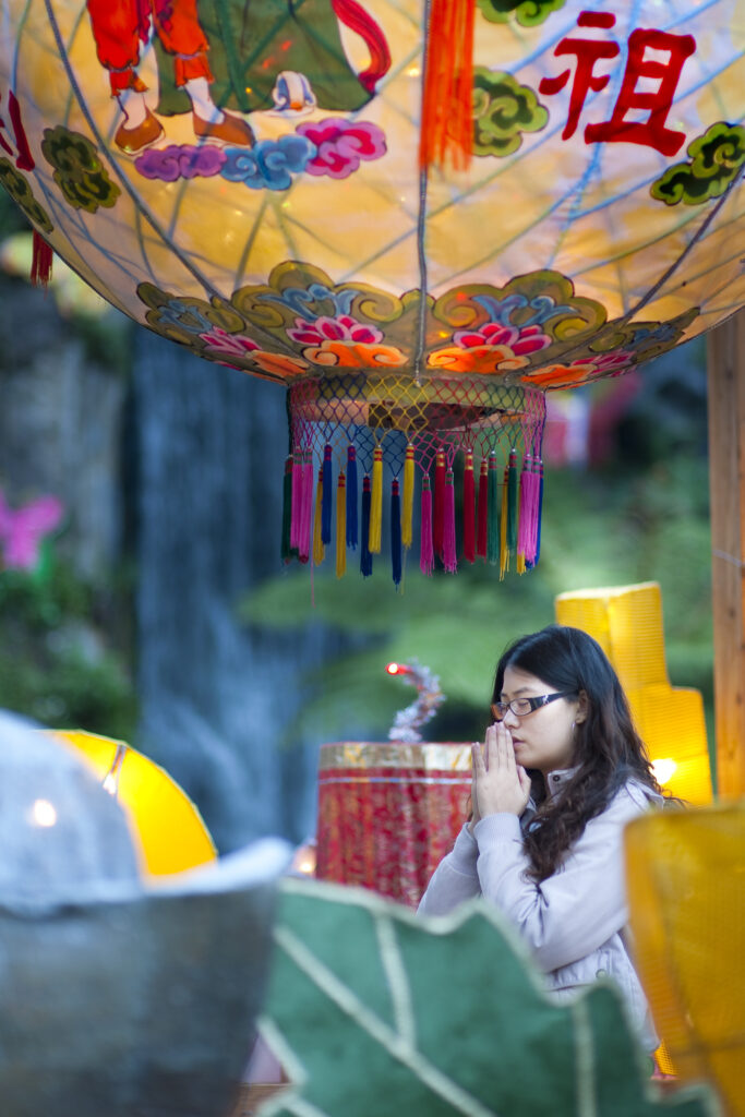 Woman praying during lantern festival, Taipei, Taiwan