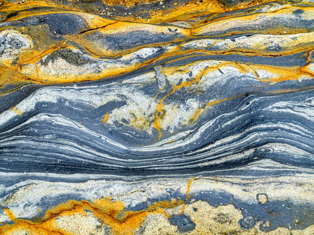The creases in this rock on Weston Beach look just like a colorful receding mountain range.
